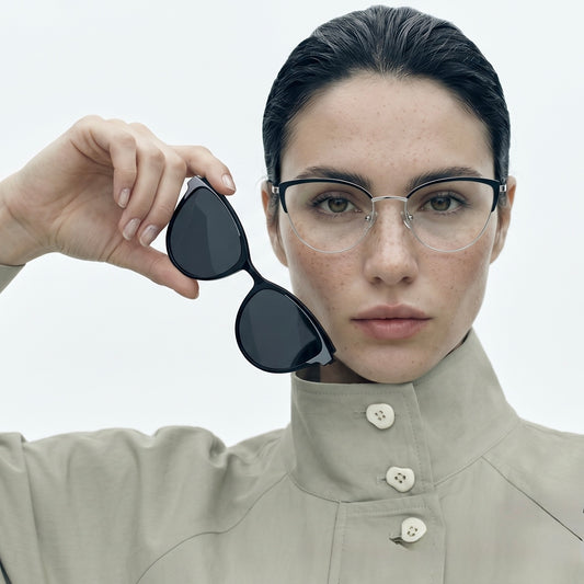 Model wearing Duo cat-eye magnetic clip-on glasses and holding the sun clip