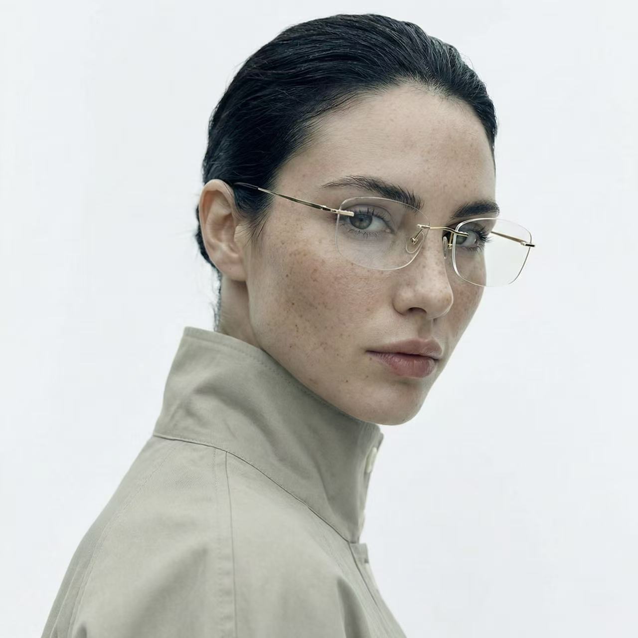 Float gold titanium rimless rectangle glasses worn by female model